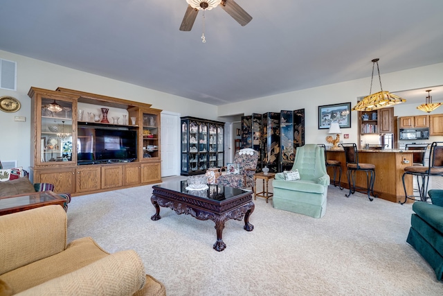 living room with light carpet and ceiling fan