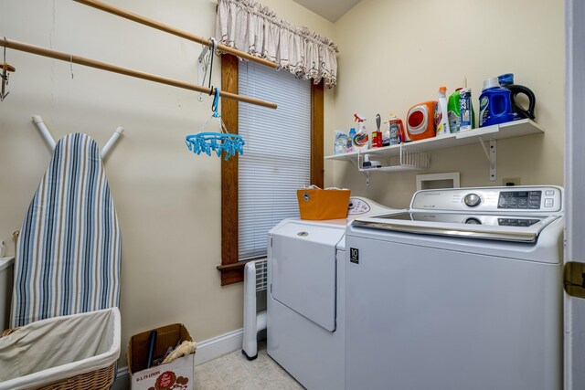 clothes washing area featuring washing machine and dryer and light tile patterned flooring