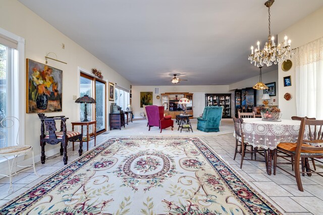 dining room featuring ceiling fan with notable chandelier