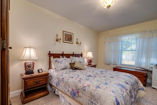 bedroom featuring light carpet