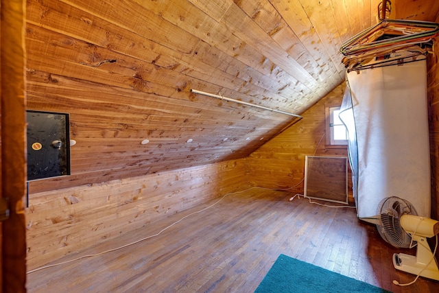 additional living space with lofted ceiling, wooden walls, hardwood / wood-style floors, and wooden ceiling