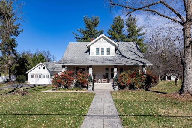 bungalow-style home with a garage, a front yard, and a porch