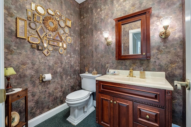 bathroom with vanity, tile patterned flooring, and toilet