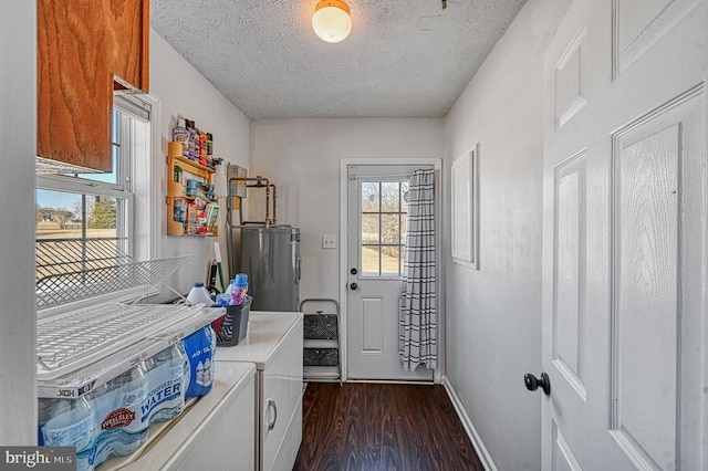 clothes washing area with water heater, laundry area, dark wood-style floors, and a healthy amount of sunlight