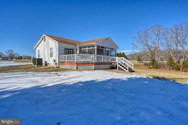 view of front of home with stairway, cooling unit, and a sunroom