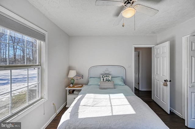 bedroom featuring multiple windows, dark wood finished floors, and baseboards