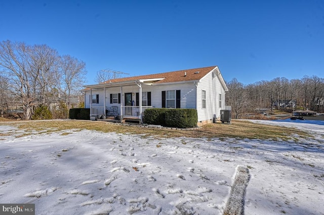 view of front of property featuring covered porch and cooling unit