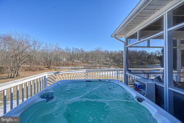 wooden deck featuring a hot tub