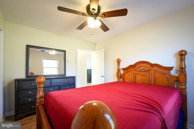 bedroom with hardwood / wood-style floors and ceiling fan