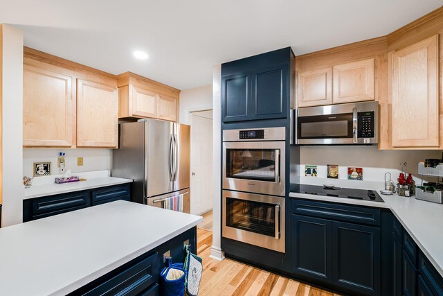 kitchen with sink, stainless steel appliances, and light brown cabinets