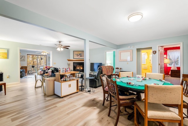 dining space featuring ceiling fan, plenty of natural light, and light wood-type flooring