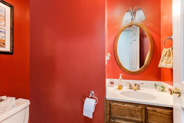 bathroom featuring vanity and toilet