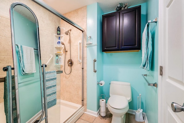 bathroom with an enclosed shower, tile patterned floors, and toilet