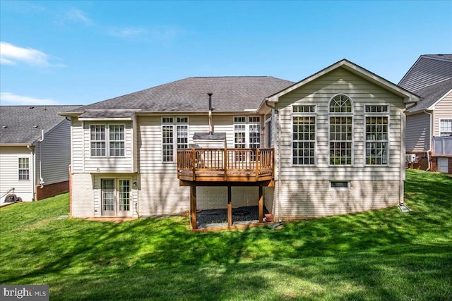 back of property with a lawn and a deck