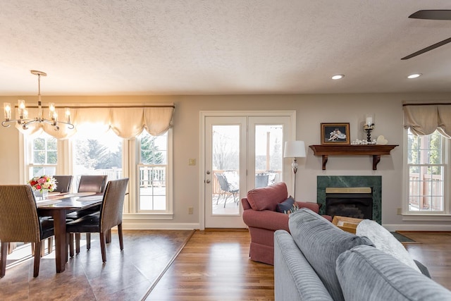 dining room with a healthy amount of sunlight, a fireplace, and wood finished floors