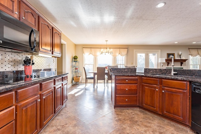 kitchen featuring dark stone counters, a sink, backsplash, and black appliances