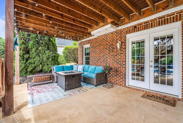 view of patio / terrace with an outdoor living space with a fire pit and french doors