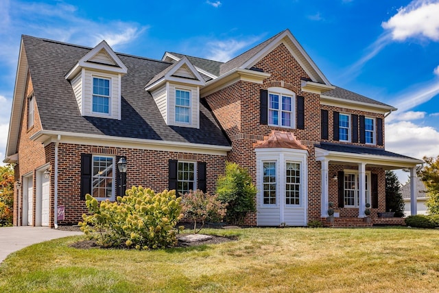 view of front of house featuring brick siding, a shingled roof, concrete driveway, a front yard, and a garage