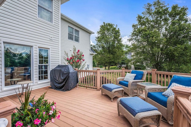 wooden terrace with grilling area and an outdoor hangout area