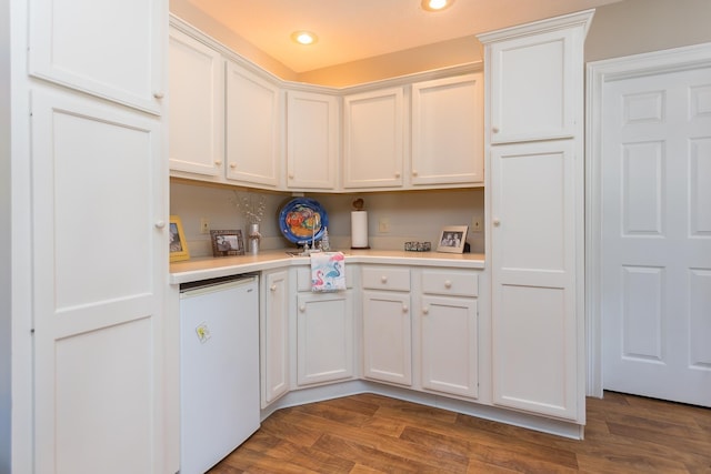 kitchen featuring white cabinetry, light countertops, dark wood-style flooring, and recessed lighting