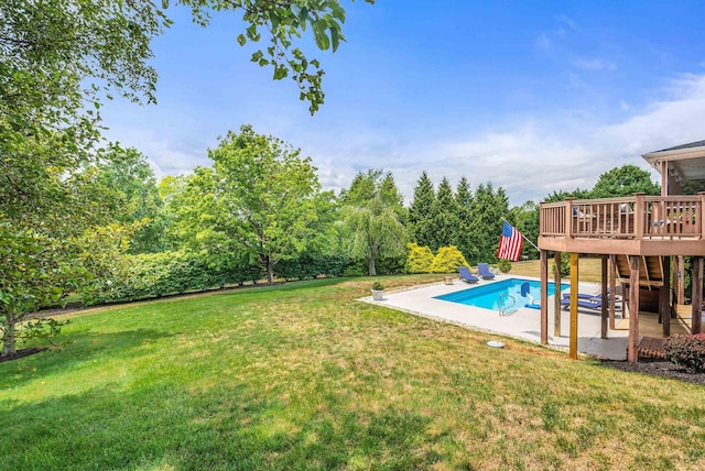 outdoor pool featuring a patio, a lawn, and a wooden deck