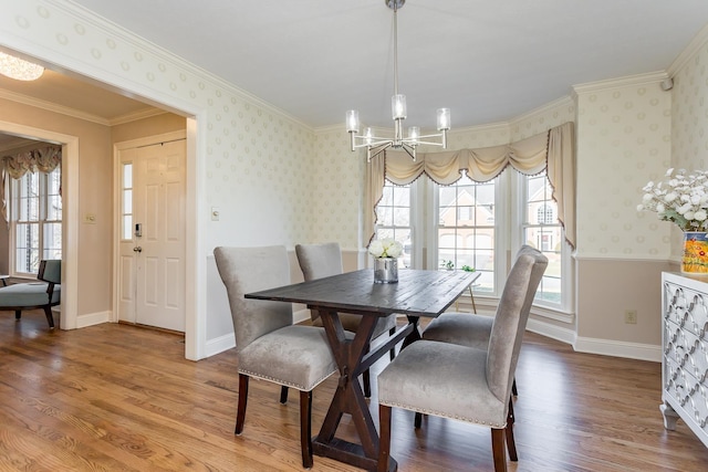 dining room featuring light wood-type flooring, a notable chandelier, baseboards, and wallpapered walls