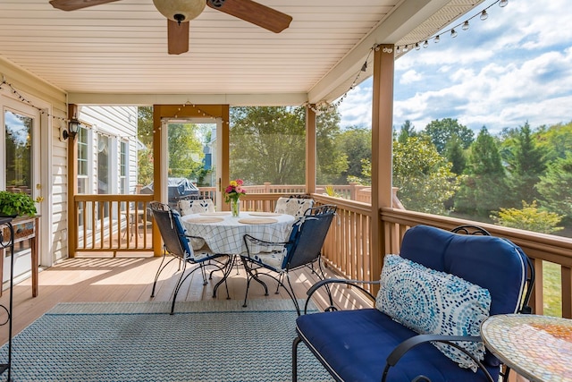 sunroom / solarium featuring rail lighting and ceiling fan