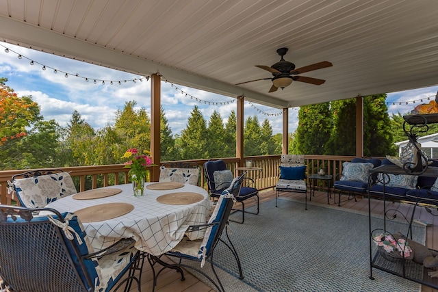 view of patio with ceiling fan, outdoor dining area, an outdoor hangout area, and a wooden deck