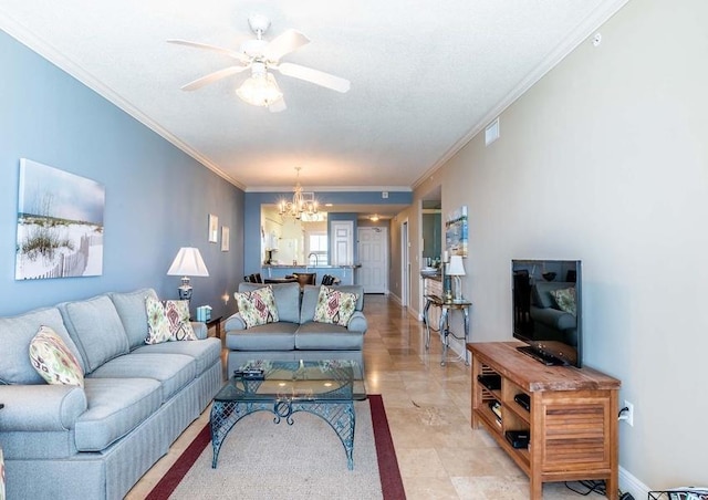 tiled living room with ceiling fan with notable chandelier and ornamental molding