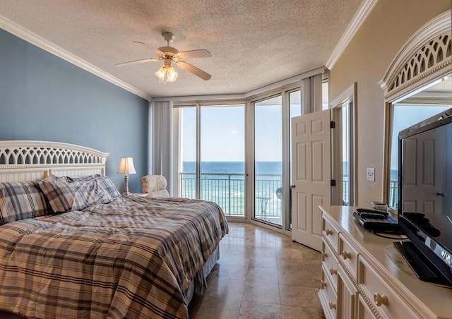 tiled bedroom featuring a textured ceiling, ceiling fan, access to exterior, and a water view