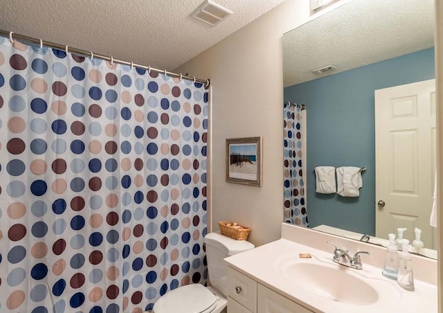 bathroom featuring a textured ceiling, vanity, and toilet