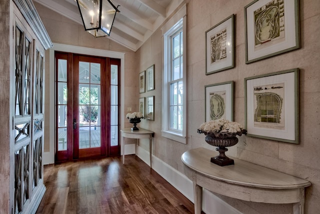 foyer with vaulted ceiling with beams, plenty of natural light, french doors, and dark wood-type flooring