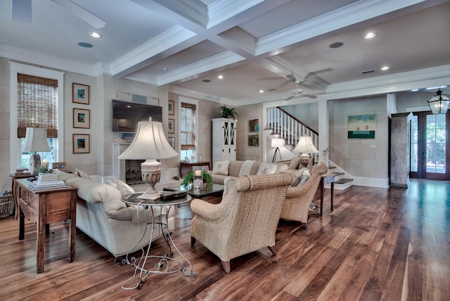 living room with ceiling fan, coffered ceiling, beamed ceiling, hardwood / wood-style floors, and ornamental molding