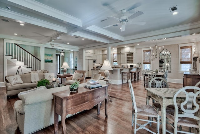 living room featuring ceiling fan with notable chandelier, coffered ceiling, beamed ceiling, hardwood / wood-style floors, and ornamental molding