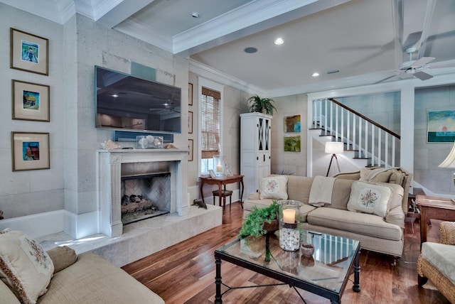 living room featuring wood-type flooring, ceiling fan, and crown molding