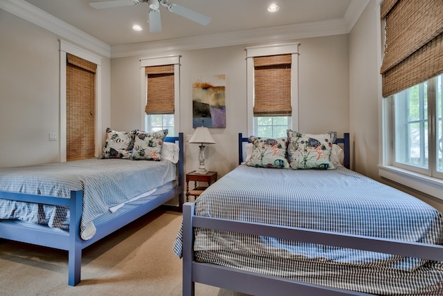 bedroom with crown molding, carpet, ceiling fan, and multiple windows