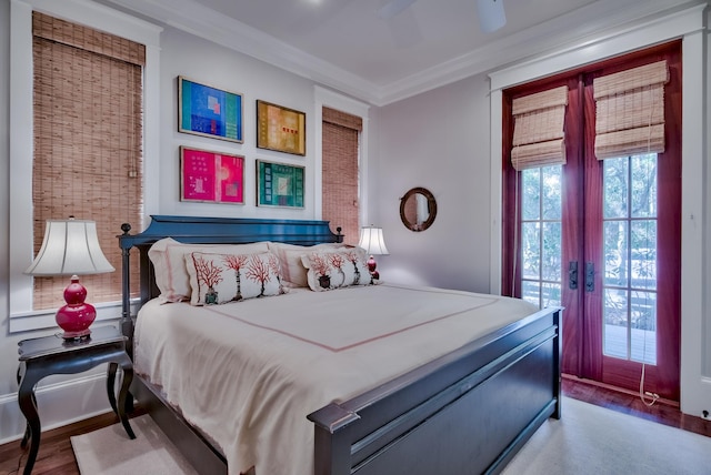 bedroom with hardwood / wood-style floors, ceiling fan, access to exterior, and ornamental molding