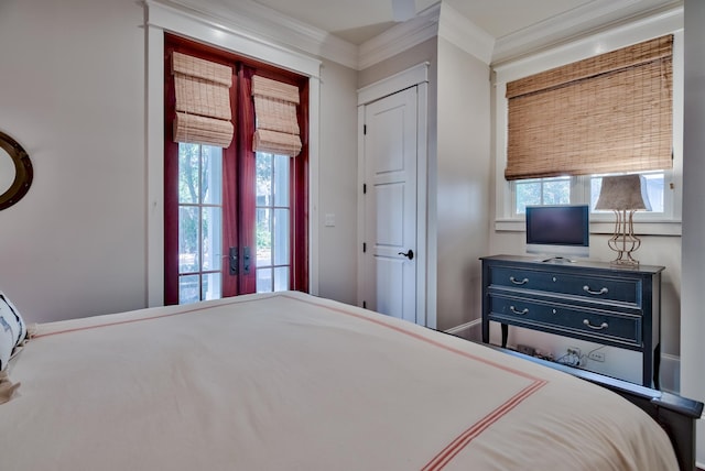 bedroom with ornamental molding, a closet, multiple windows, and french doors