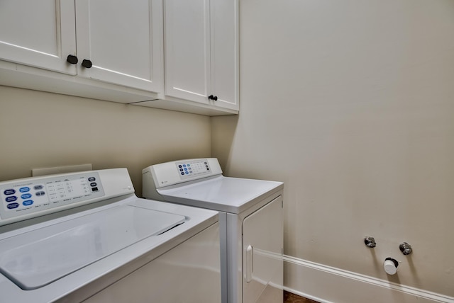 laundry area with cabinets and washer and clothes dryer