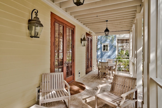 sunroom featuring beam ceiling and a wealth of natural light