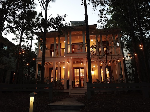 back of house featuring a balcony