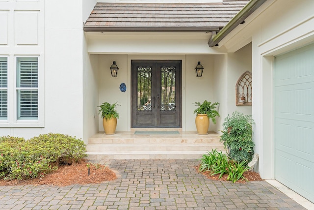 3163 Club Dr, Miramar Beach, FL 32550 - doorway to property featuring stucco siding, french doors, and a garage