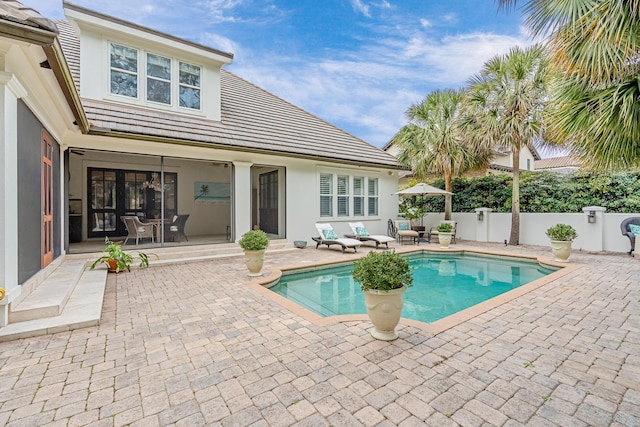 view of swimming pool with a fenced in pool, fence, and a patio area