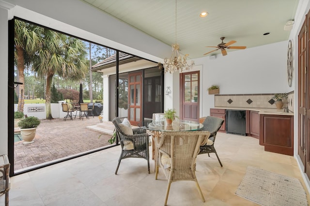 view of patio featuring outdoor dining space, exterior kitchen, french doors, and ceiling fan