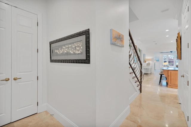 hall featuring stairway, recessed lighting, and baseboards