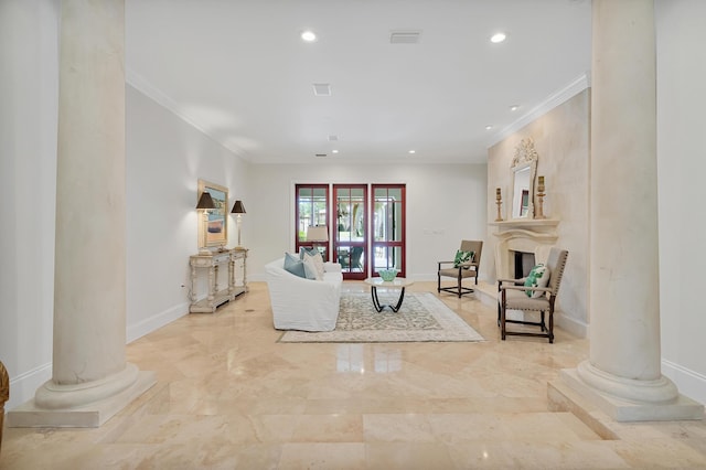 living area with baseboards, marble finish floor, ornamental molding, and ornate columns