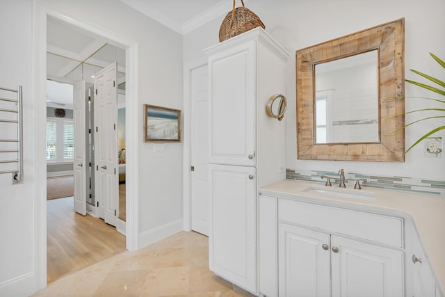 bathroom with vanity, baseboards, and ornamental molding