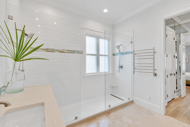 full bath with a sink, radiator, ornamental molding, and a shower stall