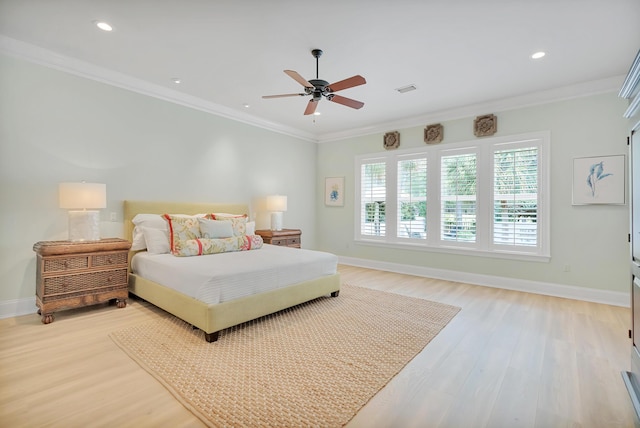 bedroom with crown molding, baseboards, and light wood-type flooring