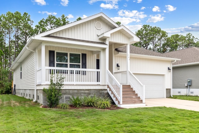 view of front of property with covered porch, a front yard, and a garage